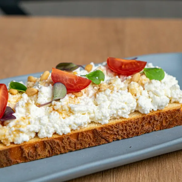 Toast topped with cottage cheese and cherry tomatoes