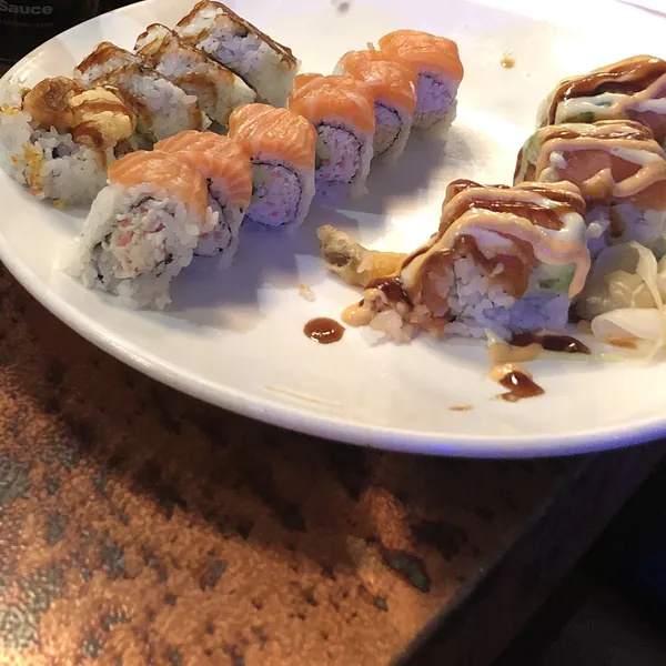 A plate of salmon sushi rolls at a restaurant